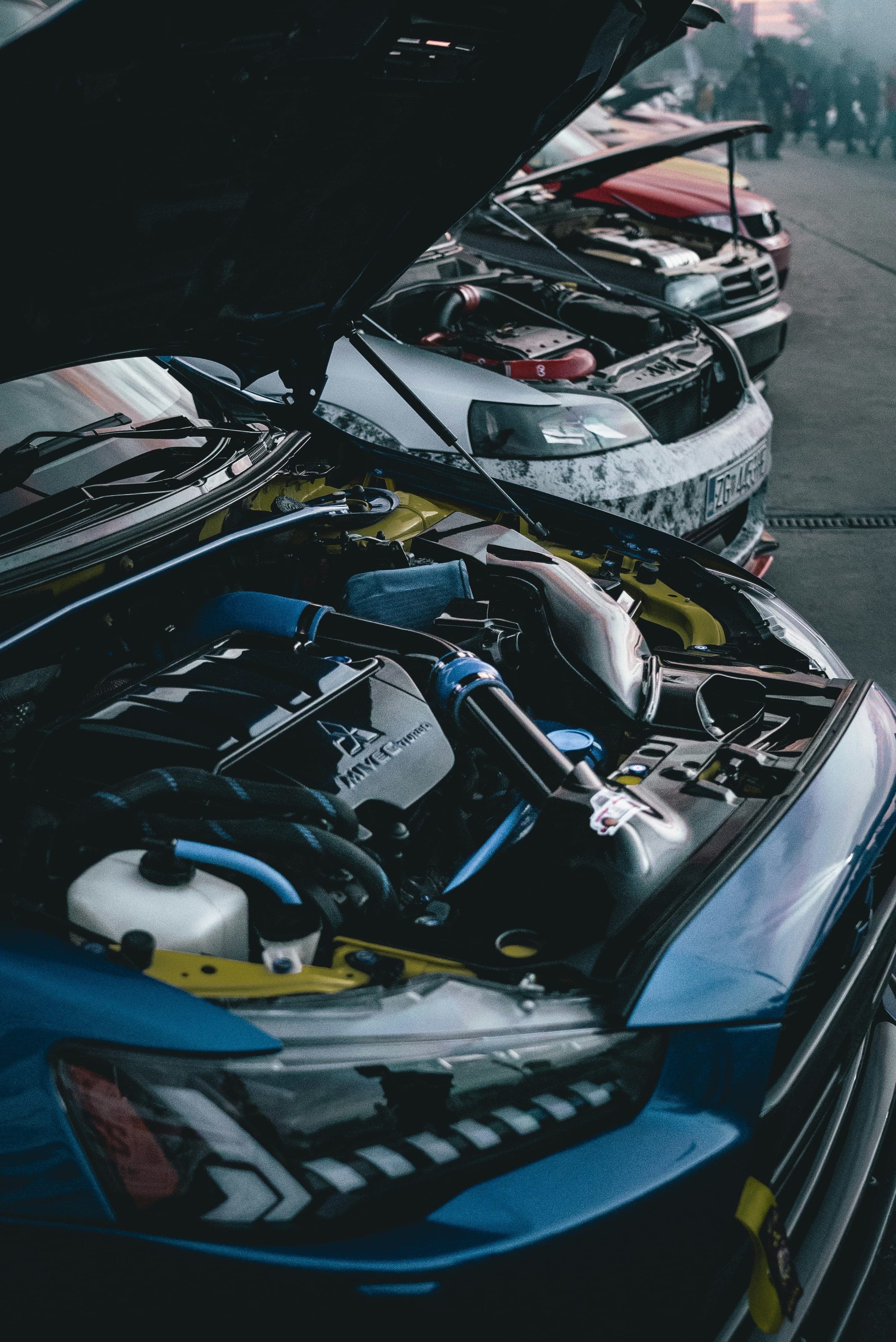 Row of bonnets at a car meet