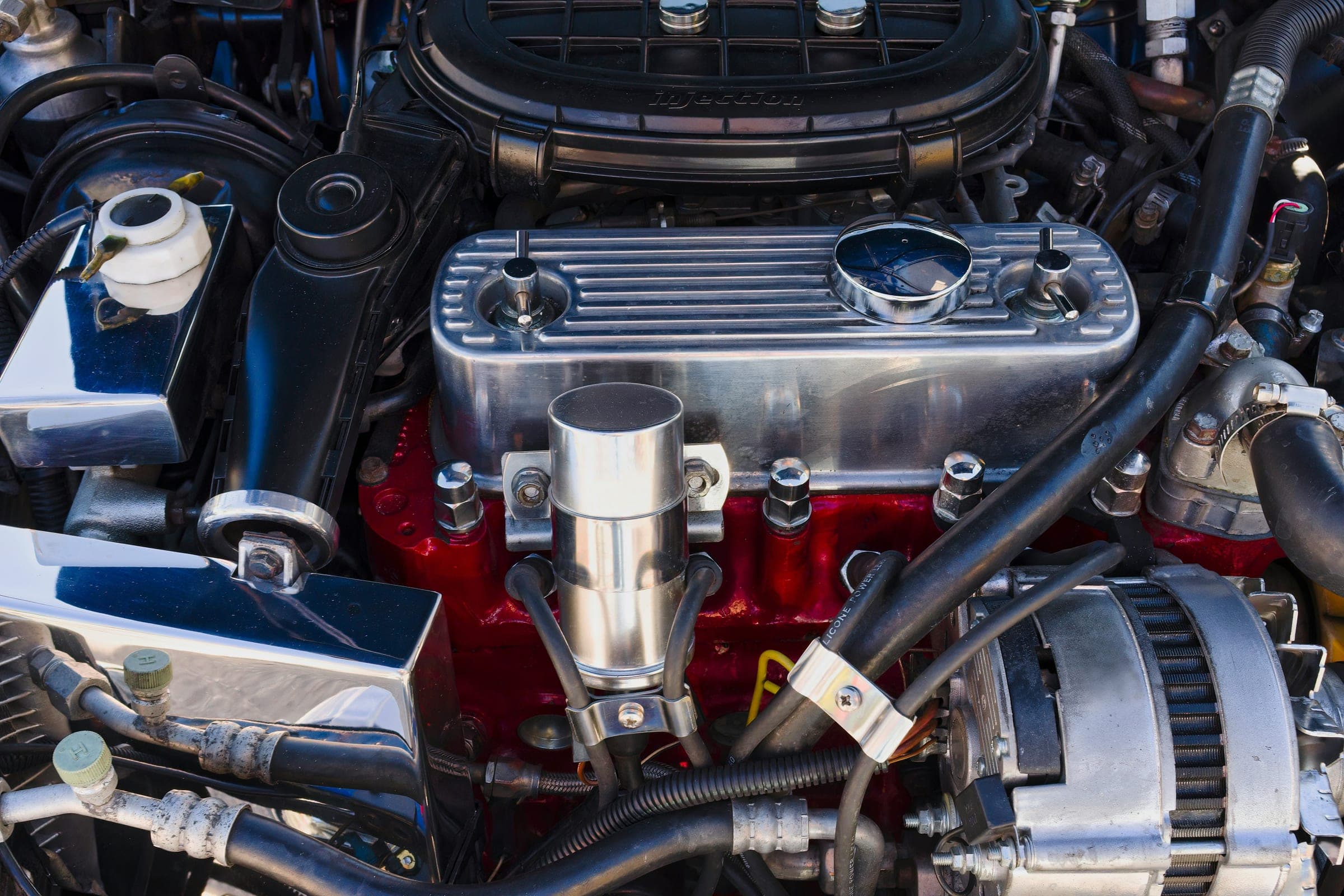 Chromed V8 engine bay with a deep-red engine block